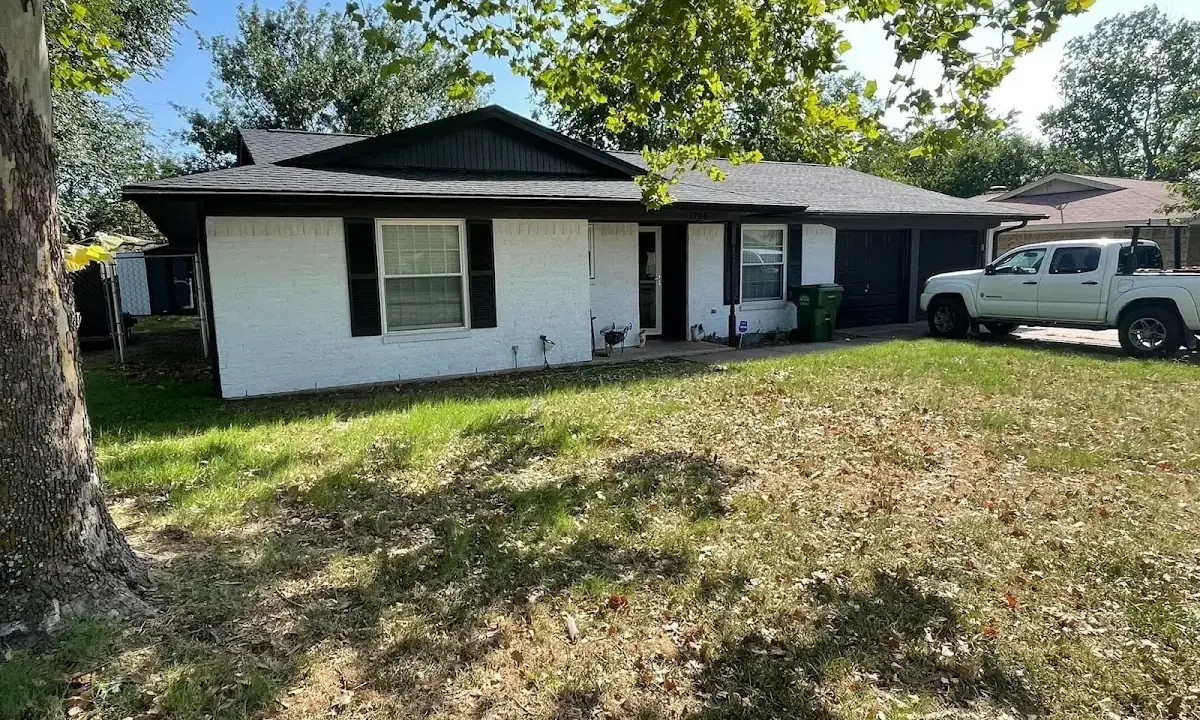 Professional roofing crew working on a residential roof in Laredo